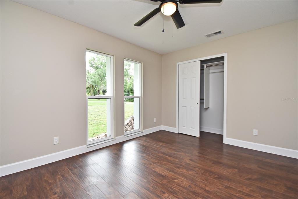 1444 Bird Road Casselberry, FL 32707 - Photo 31 of 70 a view of an empty room with wooden floor and a window