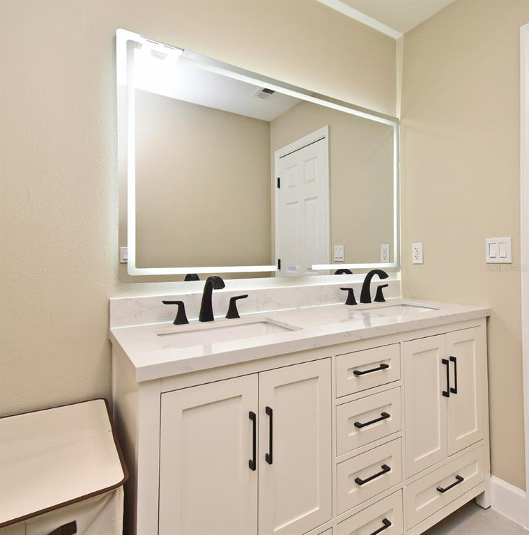 1444 Bird Road Casselberry, FL 32707 - Photo 37 of 70 a bathroom with a sink and a mirror