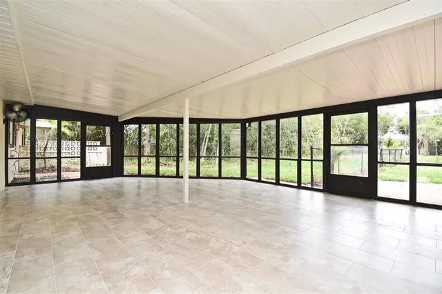 a view of a house with a yard and a large tree
