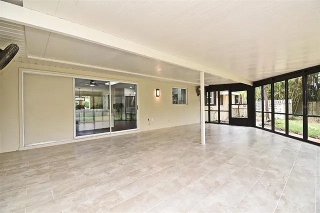 a backyard of a house with a yard and outdoor seating