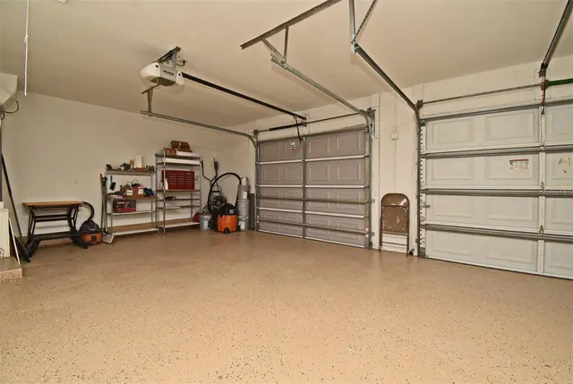 an aerial view of residential house with outdoor space and trees all around