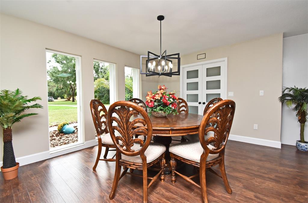 1444 Bird Road Casselberry, FL 32707 - Photo 7 of 70 a view of a dining room with furniture window and wooden floor
