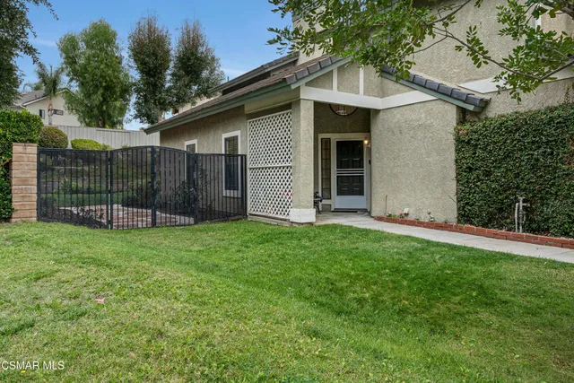a view of a house with a backyard