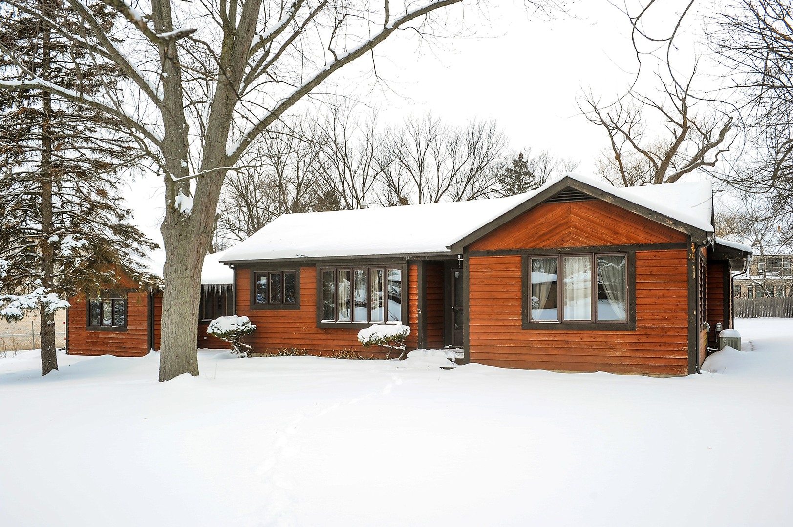 2120 Beechnut Road Northbrook, IL 60062 - Photo 1 of 10 a front view of a house with a yard covered in snow