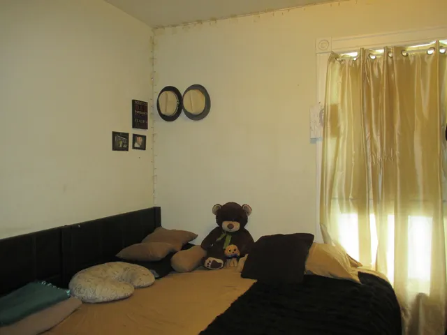 a bedroom with a bed and a mirror