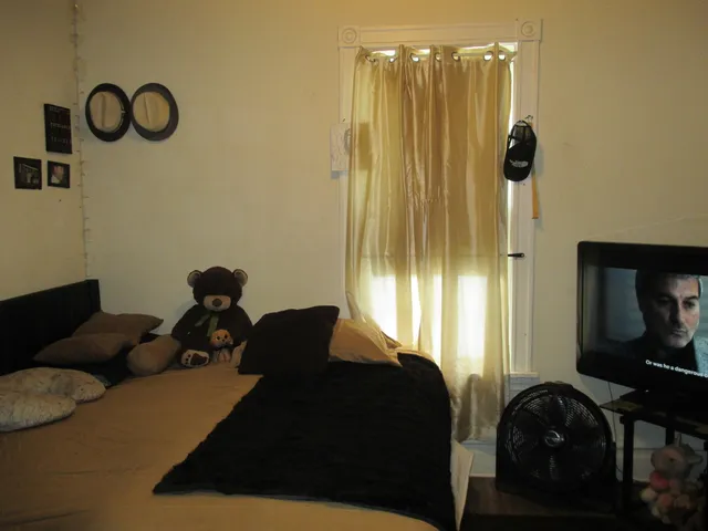 a bedroom with a bed and a chair