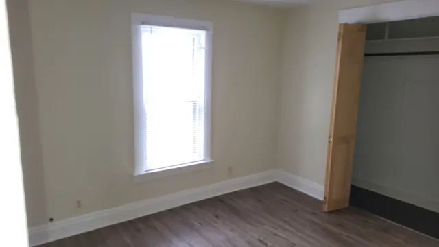 a view of a room with rack on the wall and a window