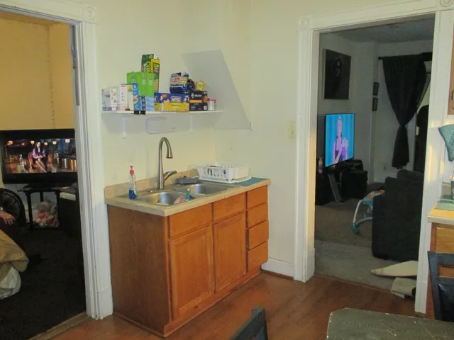 a utility room with wooden floor washer and dryer
