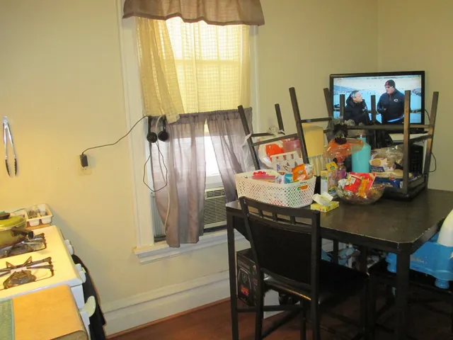 a view of a dining room with furniture and a window