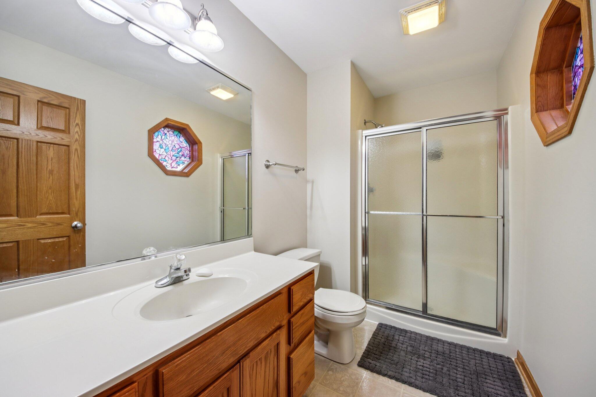 9396 Calumet Street Dyer, IN 46311 - Photo 27 of 43 a bathroom with a sink a toilet and shower