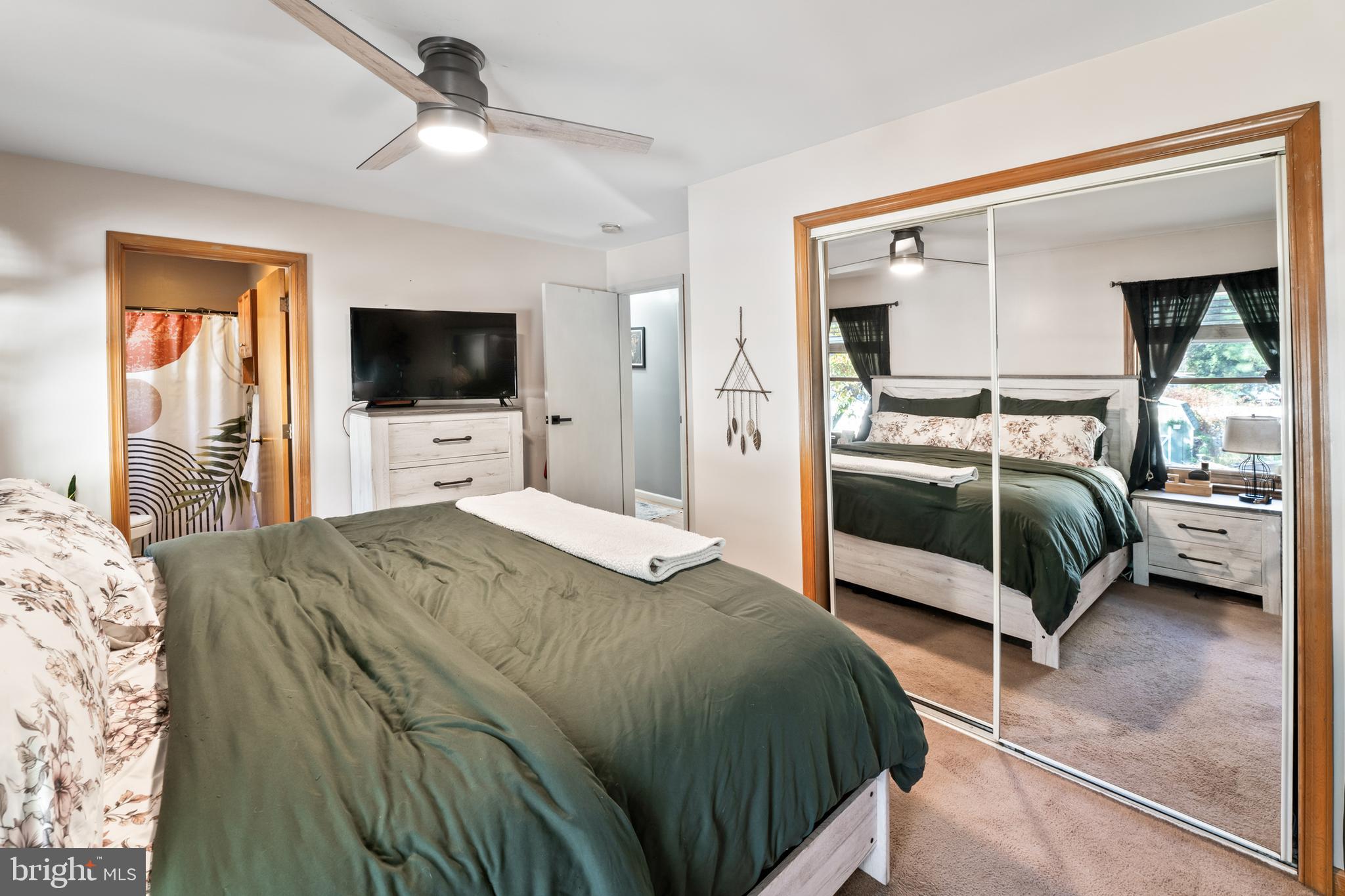 311 Tyler Avenue Carneys Point, NJ 08069 - Photo 13 of 29 a bedroom with a bed and a flat tv screen on dresser