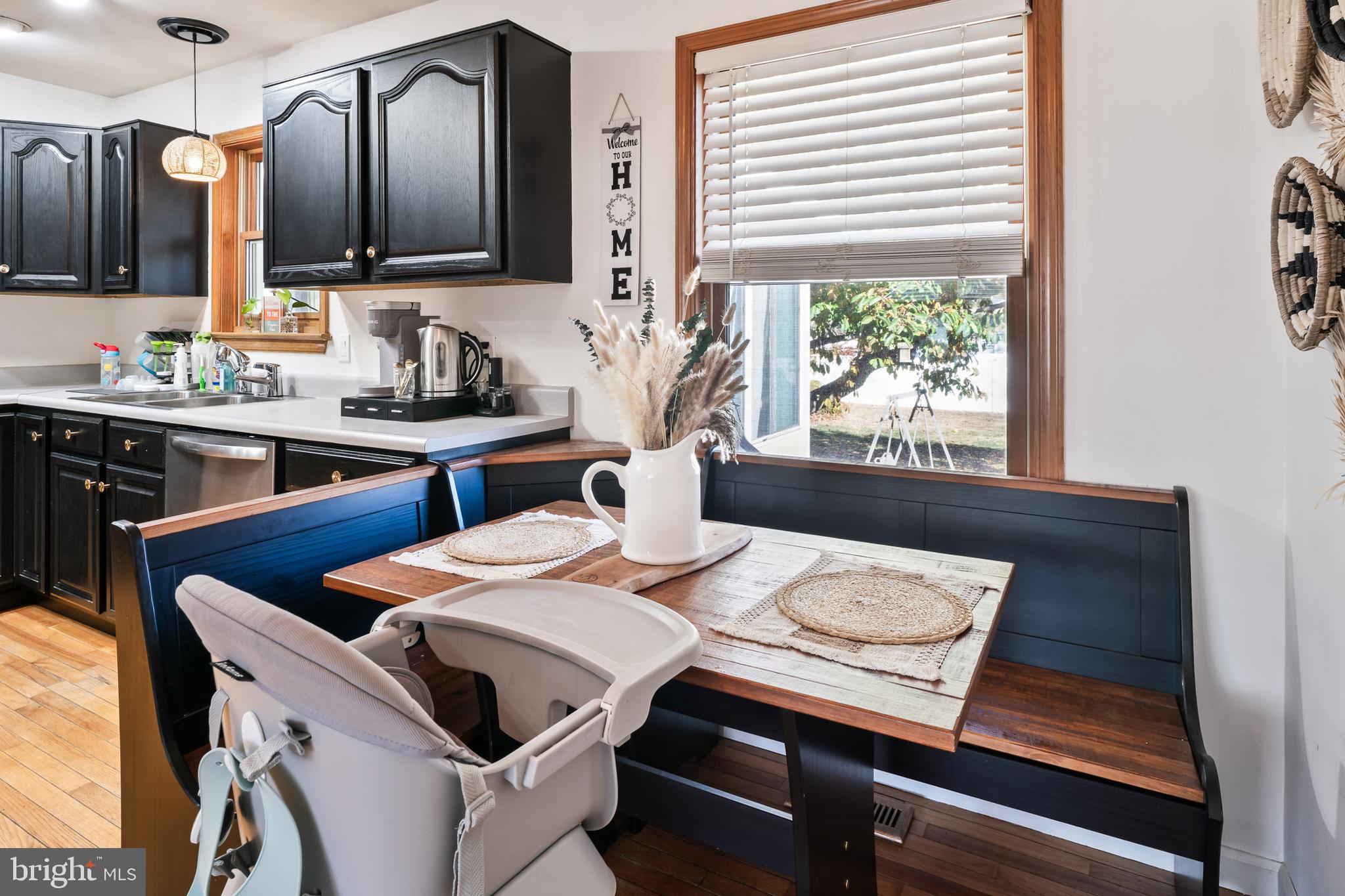 311 Tyler Avenue Carneys Point, NJ 08069 - Photo 7 of 29 a kitchen with a stove a sink and a dining table