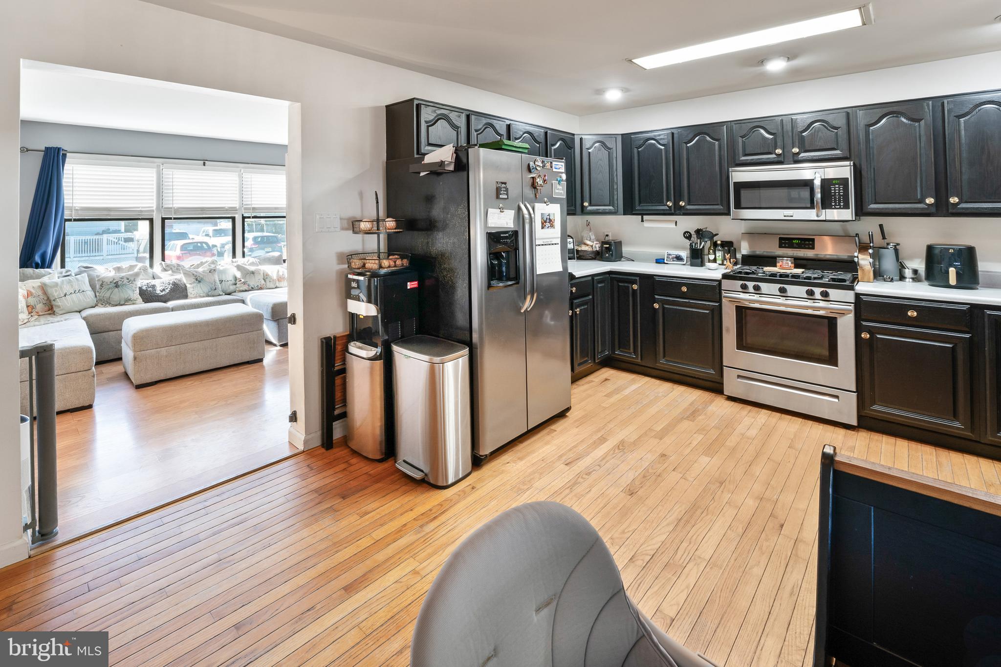 311 Tyler Avenue Carneys Point, NJ 08069 - Photo 8 of 29 a kitchen with stainless steel appliances kitchen island granite countertop a refrigerator stove and oven
