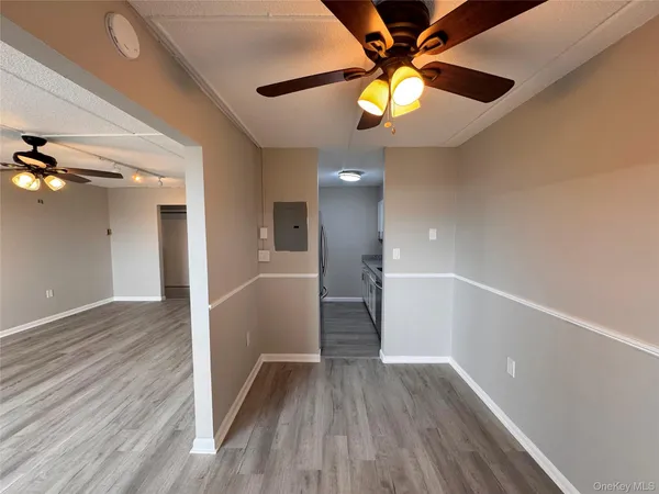 a kitchen with stainless steel appliances granite countertop a refrigerator a sink a stove and white cabinets