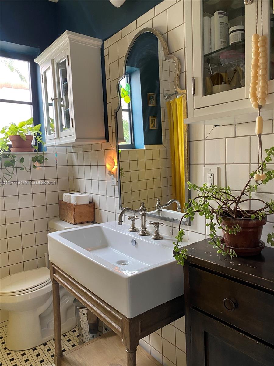 Hollywood Lakes North Lake Hollywood, FL 33019 - Photo 14 of 22 a bathroom with a sink and a mirror