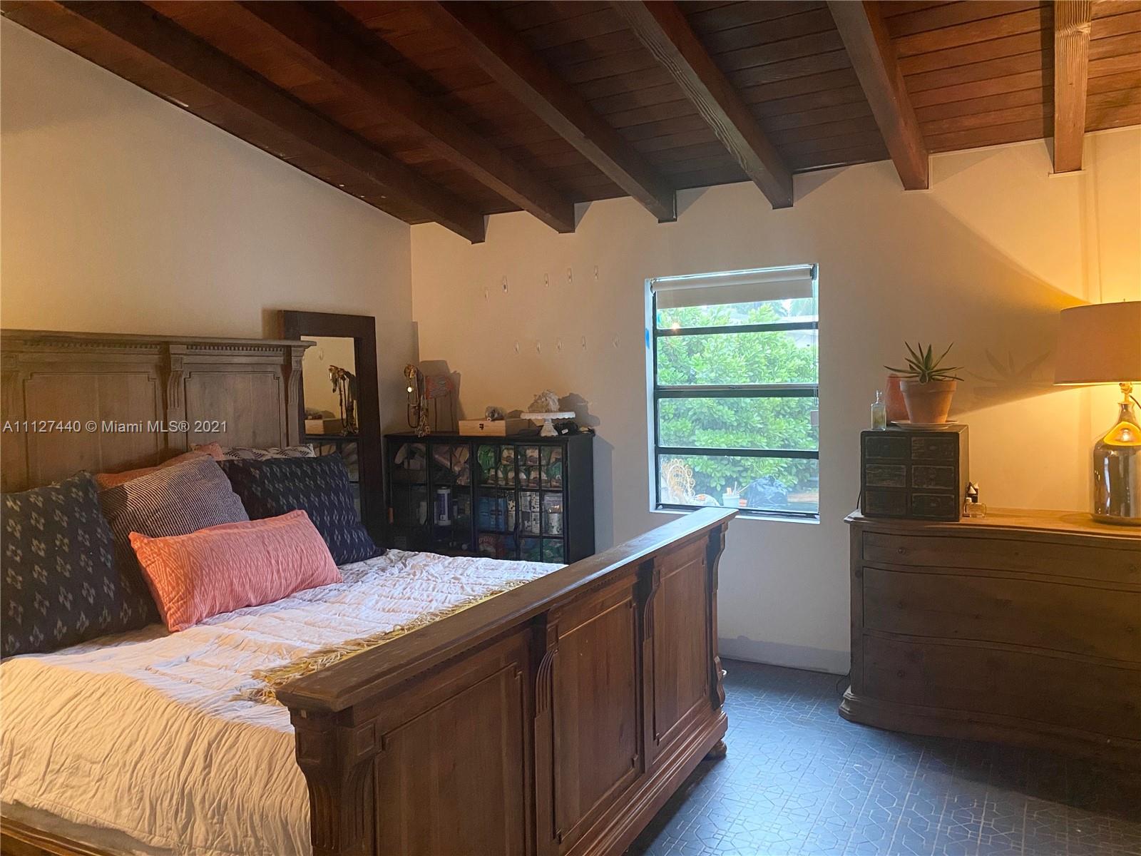 Hollywood Lakes North Lake Hollywood, FL 33019 - Photo 16 of 22 a bedroom with a bed and large windows