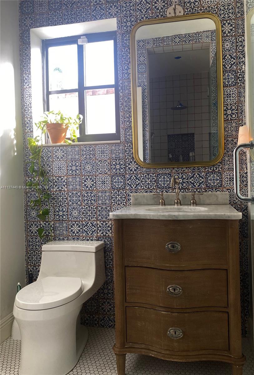 Hollywood Lakes North Lake Hollywood, FL 33019 - Photo 17 of 22 a bathroom with a sink a toilet and a mirror