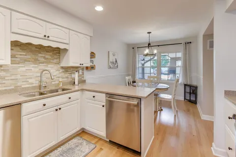 a kitchen with sink cabinets and wooden floor