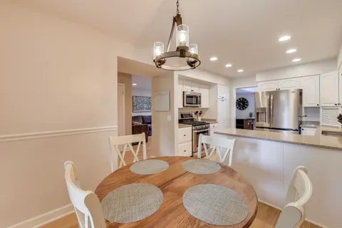 a dining room with furniture and window