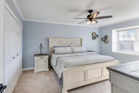 a bedroom with a bed and a chandelier