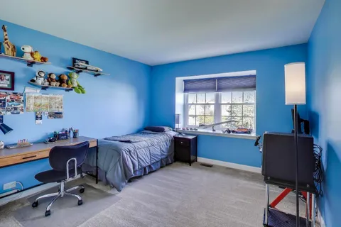 a bedroom with a workspace