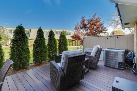 a view of a deck with furniture and wooden floor