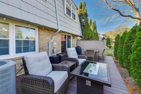a view of a patio with couches table and chairs and potted plants