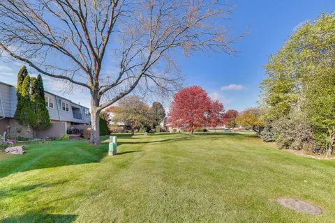 a swimming pool with outdoor seating and yard
