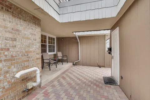 a backyard of a house with outdoor seating