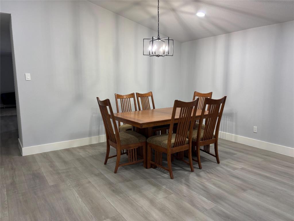 2005 Chestnut Road Carrollton, TX 75007 - Photo 15 of 35 a view of a dining room with furniture and chandelier