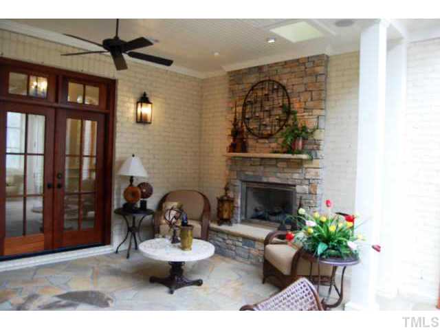 924 Cowper Drive Raleigh, NC 27608 - Photo 11 of 12 Covered porch with stone fireplace
