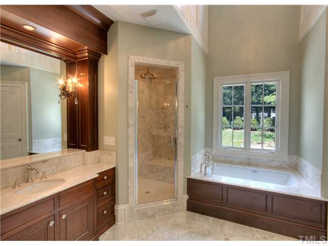 924 Cowper Drive Raleigh, NC 27608 - Photo 8 of 12 Master bath with custom mahogany cabinetry, marble tile and flooring, and Rohl fixtures with Swarovski crystal handles
