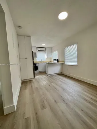 a view of kitchen and wooden floor
