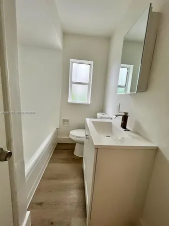 a bathroom with a sink a toilet and bathtub