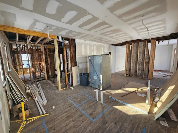 a view of a livingroom with wooden floor and stairs