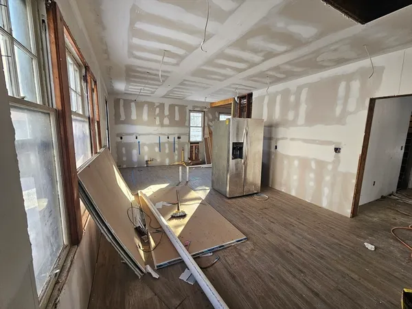 a view of a balcony with wooden floor and furniture