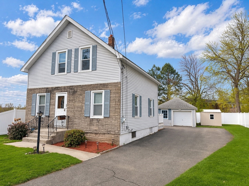 a view of house that has a yard