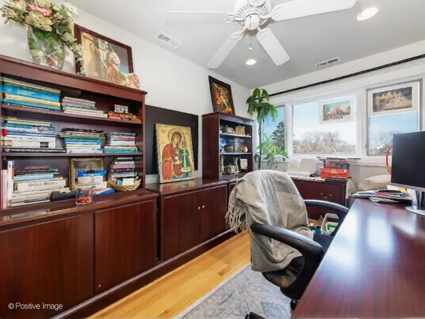 a work room with wooden floor and furniture