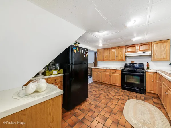 a kitchen with a refrigerator and a stove