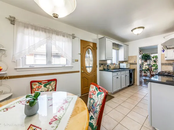 a kitchen with stainless steel appliances granite countertop a refrigerator sink and white cabinets