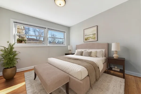 a bedroom with a large bed and a potted plant