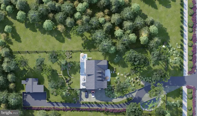 an aerial view of residential houses with outdoor space and trees