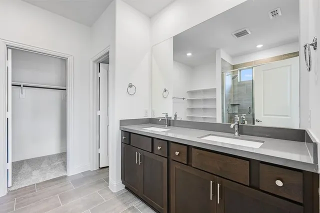 a sink with a mirror and a shower