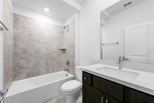 a bathroom with a sink a toilet a bathtub and shower