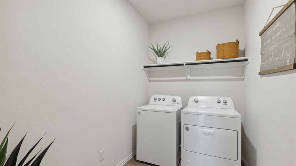 126 Pheasant Run Road Terrell, TX 75160 - Photo 25 of 26 Laundry area with washer and clothes dryer and baseboards
