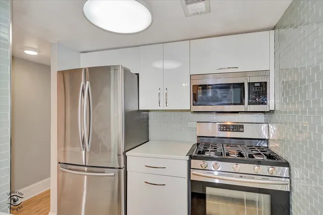 a kitchen with a stove and a microwave