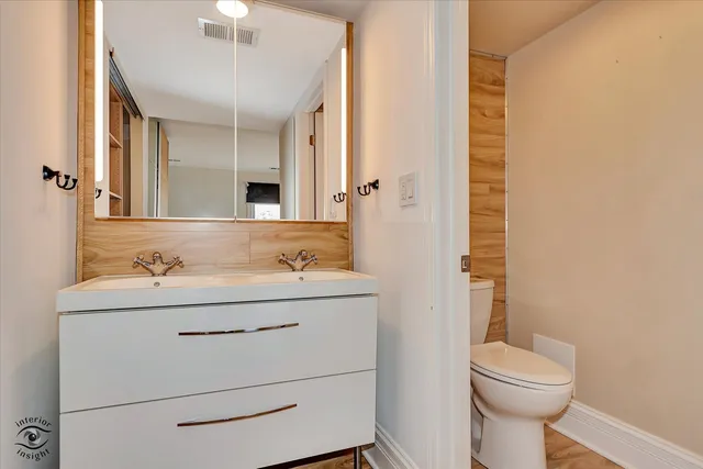 a bathroom with a sink a toilet and mirror