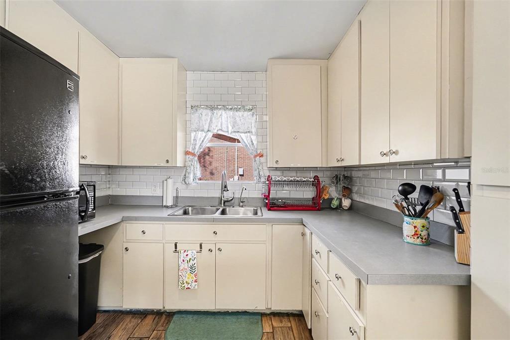2102 Columbus Drive Brandon, FL 33510 - Photo 14 of 28 a kitchen with a sink a stove a microwave and cabinets