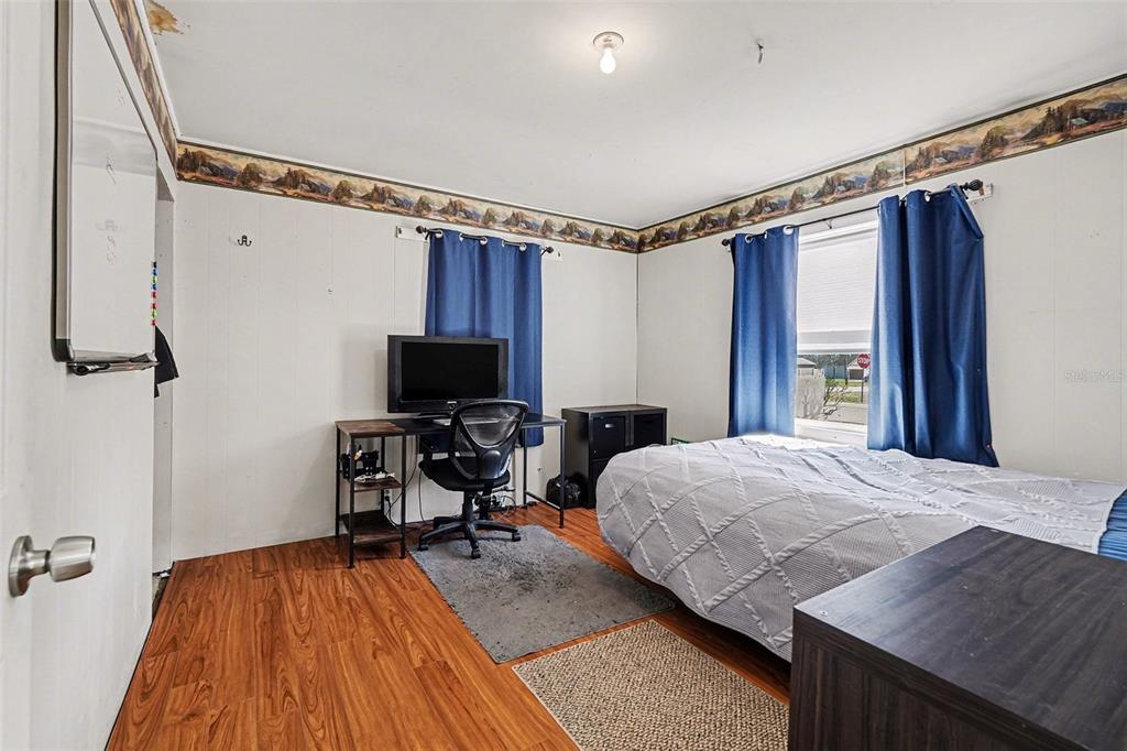 2102 Columbus Drive Brandon, FL 33510 - Photo 17 of 28 a bedroom with a bed and a flat screen tv