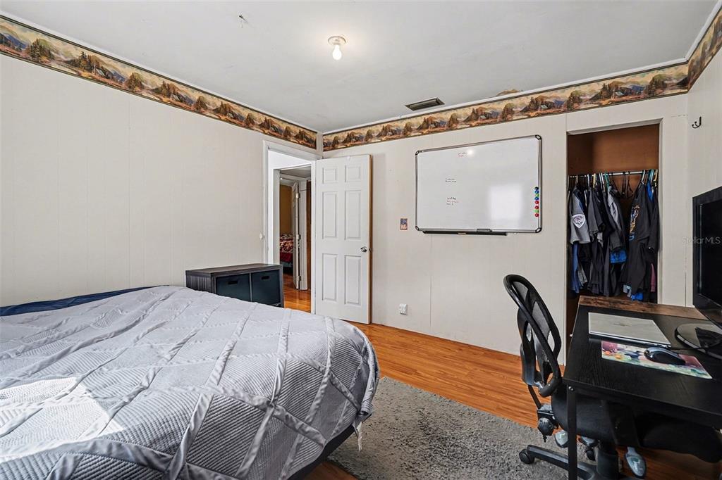 2102 Columbus Drive Brandon, FL 33510 - Photo 19 of 28 a bedroom with a bed and a desk